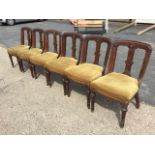 A set of six late Victorian mahogany dining chairs, the rectangular moulded backs having roundels to