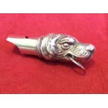A silver dog whistle cast as a retriever with ring to mouth - 925 marks. (2.5in)