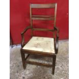 A nineteenth century stained armchair, the back with rails framing bobbins flanked by elm stiles,