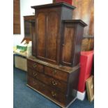 A nineteenth century breakfront estate cupboard, the central section with arched panelled door