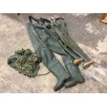 Two pairs of chest waders - small size; and a small camouflage waistcoat with pockets. (3)