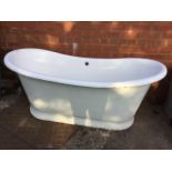 A cast iron enamelled bath with rounded shaped ends having central plug & tap hole, the tapering tub