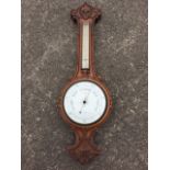 A Victorian oak barometer, the scroll carved case with leaves, flowers & berries, having rectangular
