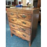 An early nineteenth century mahogany chest of drawers, having inlaid frieze above two short and