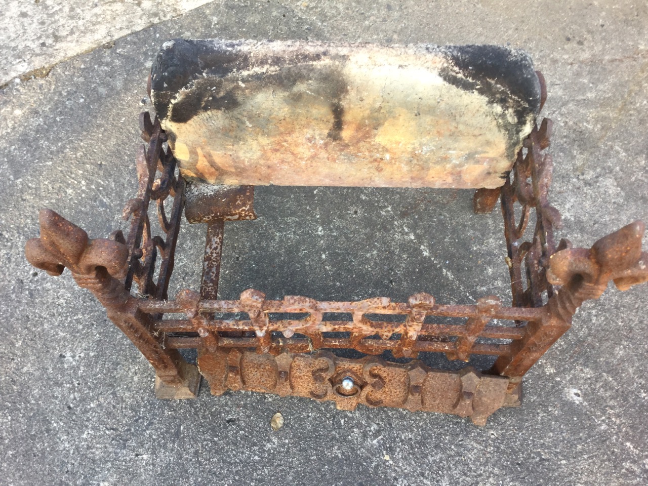 A rectangular wrought iron dog grate, having firebrick back and riveted trellis framed basket, the - Image 2 of 3