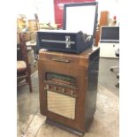 A Portadyne walnut cased valve radio, the hinged lid formerly housing a gramophone, the radio with