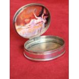 An oval sterling silver pill pot, the hinged lid embossed with scrolled border, having interior with