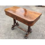 A George IV rosewood turn-over-top card table, the rounded leaves having baize lined interior