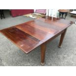 A mahogany draw-leaf dining table, the panelled rectangular top on square tapering legs. (71in x