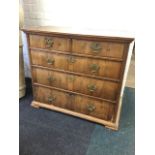 A Queen Anne walnut chest with oak top above moulded cornice and two short and three long