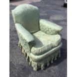 A small Edwardian upholstered armchair with damask loose covers, the arched padded back above a long