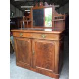 A Victorian mahogany dresser, the back with bevelled mirror in reeded frame surmounted by scroll