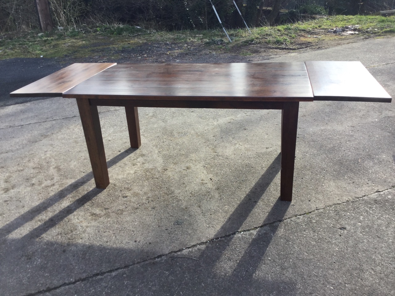 A rectangular hardwood dining table with two spare leaves, raised on square column legs. (95in x - Image 3 of 3