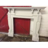 A large painted chimneypiece, the moulded mantelpiece with dentil band supported on four fluted