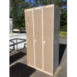 A tall metal cabinet with three lockers. (35.5in x 17.75in x 69.75in)