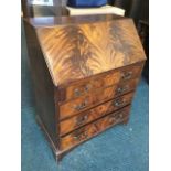 A reproduction Georgian style mahogany bureau, the flame veneered fallfront with mechanical lopers