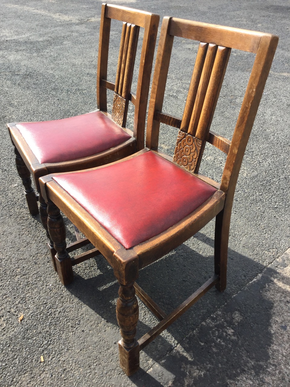 A pair of 1930s oak chairs with fluted splats above stylised carved roundel panels, the drop-in - Image 2 of 3