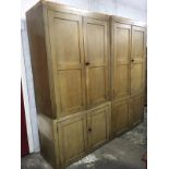 A large Victorian scumbled pine housemaids cupboard, the four pieces with panelled doors enclosing
