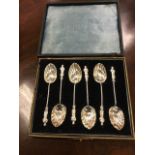 A cased set of hallmarked silver coffee spoons with shell embossed bowls and twisted shafts
