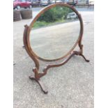 A large oval Edwardian mahogany dressing table mirror, the plate in frame inlaid with chequered