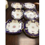 A Coalport twelve-piece dessert service decorated with polychrome floral sprigs framed by blue &