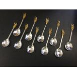 A set of ten hallmarked silver spoons, the silver gilt terminals modelled as roman centurions,