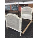 A nineteenth century painted and carved bed, the headboard & tailboard with arched rails having