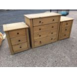 A pine bedroom suite with a pair of bedside cabinets each with three drawers, and a chest of four