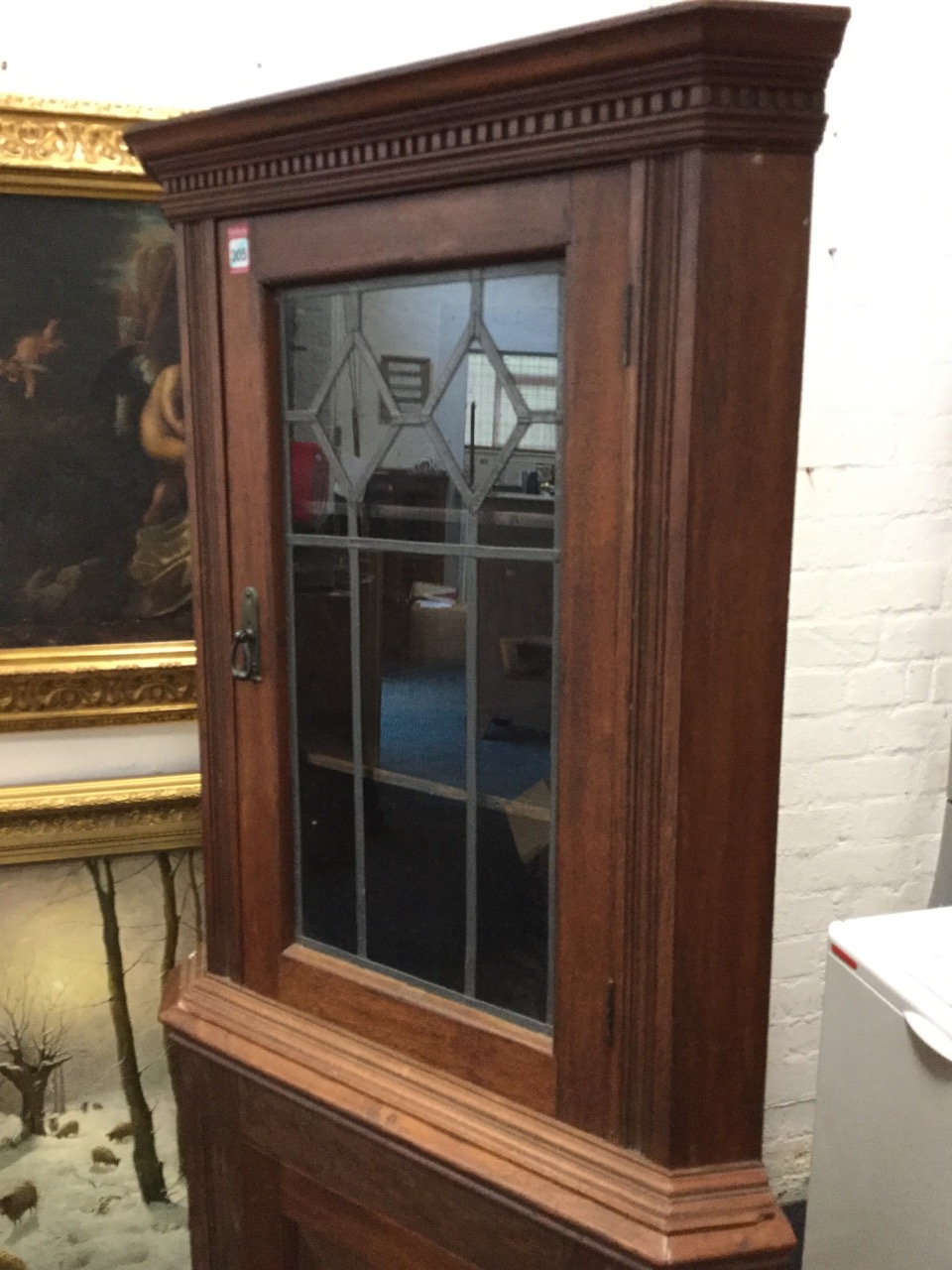 A mahogany corner cupboard with moulded dentil cornice above leaded glass door and a fielded - Image 2 of 3