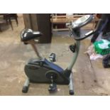 A Trimline exercise bike with adjustable padded seat, electronic dashboard, tension control, etc.