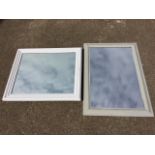 A rectangular mirror in painted moulded frame; and another in cushion moulded frame. (2)