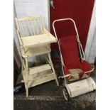 A painted childs high chair with spindle back and swinging feeding tray, folding into a play seat