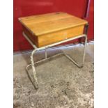 A beech school desk with hinged lid on tubular metal frame. (22.25in x 18in x 26in)