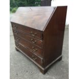 A George III mahogany bureau, the fallfront revealing an interior with inlaid central cupboard,