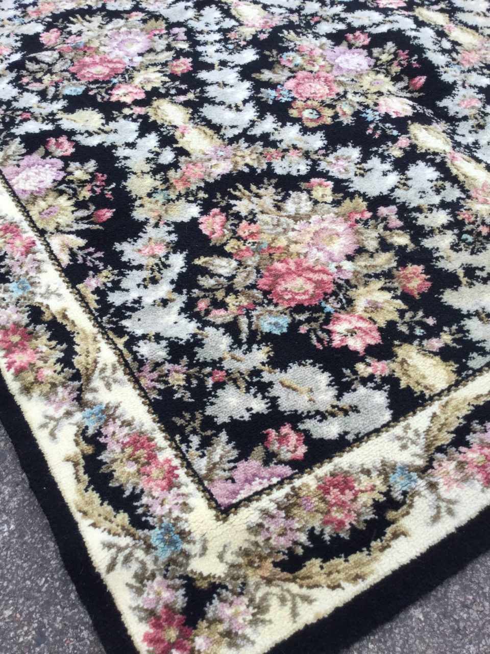 A Spanish Whitney wool rug woven in the Escorial pattern with field of flowers on black ground - Image 3 of 3