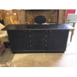 A contemporary ebonised oak sideboard with rectangular top above central bank of four graduated