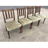 A set of four nineteenth century oak dining chairs with reeded backs framing triple moulded ribbed