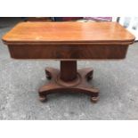 A George IV mahogany turn-over-top table, with rounded twin leaves above a deep frieze with well,