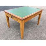 A rectangular oak writing table or desk, the rectangular moulded top inset with rexine skiver