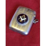 A hallmarked silver vesta case decorated with engine turned bands, mounted with a circular enamelled