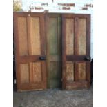 Three 2ft 6in pine doors, each with four moulded panels, mounted with rimlocks and fitted with