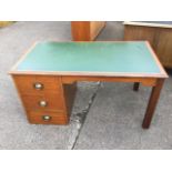 A mahogany desk, the rectangular moulded top inset with writing surface having shaped apron above