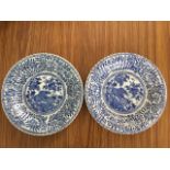 A pair of chinoiserie plates with ribbed borders decorated with circular panels of peony blossom,