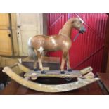 A Victorian childs rocking horse, the carved skin covered pony with glass eyes on shaped platform