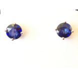 A pair of 18ct gold sapphire stud earrings, the circular claw set stones of approx 2 carats, with