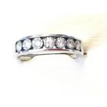 A 9ct white gold half-eternity ring, having open rectangular panel set with seven ribbed framed