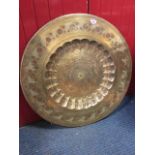 A large circular eastern brass tray decorated bands of leaves with ropetwist rim, the well with