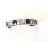 A 9ct gold half eternity ring having four bezel set sapphires alternating with star set diamonds -