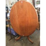 An oval Victorian mahogany loo table, the moulded tip-top on turned column with tripartite legs on