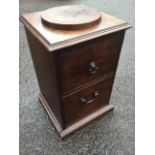 A Georgian mahogany urn stand, the square moulded top with circular tablet above a cupboard and an